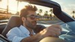 © Fotograf - A man in sunglasses driving a convertible car. Suitable for automotive and travel concepts
