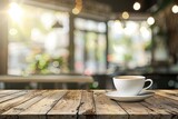 Cup of coffee on table on blurred cafe background with sunlights and outdoors