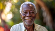 © MP Studio - A joyful elderly man smiles warmly in natural sunlight.