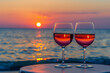 Summer love. Romantic sunset dinner on the beach. Table honeymoon set for two with luxurious food, glasses of rose wine drinks in a restaurant with sea view
