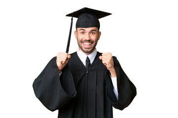 Wall Mural - Young university graduate man over isolated chroma key background celebrating a victory in winner position