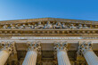 a Majestic courthouse with classical Corinthian columns under a clear sky
