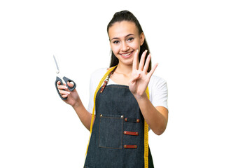 Wall Mural - Young Seamstress woman over isolated chroma key background happy and counting four with fingers