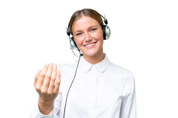 Wall Mural - Telemarketer caucasian woman working with a headset over isolated background inviting to come with hand. Happy that you came