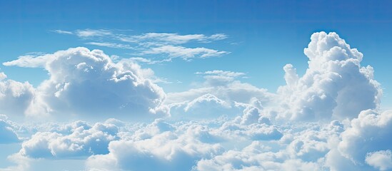 Wall Mural - numerous clouds can be seen scattered in the sky, positioned high above the earth's surface