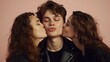 © Jafree - Young man with eyes closed receiving kisses from women. Peach background. Concept of love, youth, love triangle, affection, and polyamory.