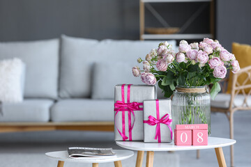 Wall Mural - Calendar with date of International Women's Day, roses and gift boxes on table in living room, closeup