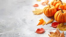 Fall Background With Orange Pumpkins And Fall Leaves On A Light Surface
