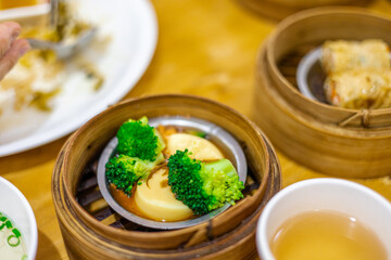 Wall Mural - The background of food that is put in a wooden container (dim sum) containing vegetables, pork, flour Used to make, a menu that requires steaming stoves for good taste, delicious to eat