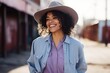 Portrait of a beautiful young woman with curly hair wearing cowboy hat