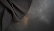black cloth shot on a dark moody black concrete background