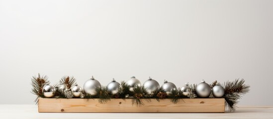 Canvas Print - A wooden rectangle box filled with Christmas decorations sitting on a table, surrounded by grass, against a backdrop of a metal flooring landscape and horizon