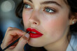 woman applying red lipstick