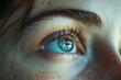 A woman's eye is open and has a blue tint to it. The eye is surrounded by a blurry background, which gives the impression of a dreamy, ethereal quality