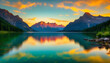 A tranquil lake at sunset with a vibrant sky and mountains in the background