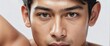 Handsome young filipino man on plain white background close up portrait shot of the face , skin care clean ad concept from Generative AI