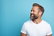 Cheerful bearded man in white t-shirt on blue background