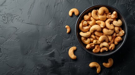 Cashew nuts in bowl at black background