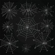 Spider web set isolated on dark background. Spooky