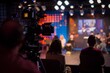 A studio audience enthusiastically participating in a live recording of a business talk show, eagerly absorbing the wisdom shared by industry thought leaders, Generative AI