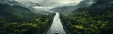 Fototapeta  - Car driving on the road in the misty rain forest. Panorama