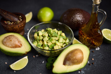 Wall Mural - Chopped avocado in glass bowl and avocado Halves