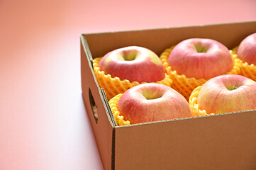 Wall Mural - beautiful pink apple in the box on pink background