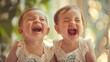 joyful twin toddler girls laughing together