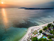 Aerial view of a beautiful tropical sunset and sandy beach resort (Gili Islands, Indonesia)