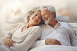 An elderly man and woman cuddling in bed, showcasing their enduring love and closeness