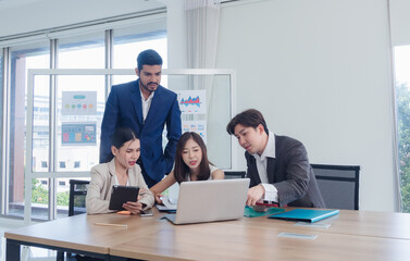 Portrait business team woman and man Asian group meeting sitting looking holding pen and look talking new project creative write note plan ready for happy working online sale inside room office