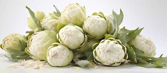 Sticker - A bunch of artichokes, a type of flowering plant, with green leaves sitting on a white surface. These natural foods are a delicious and healthy vegetable ingredient, perfect for local food events