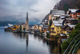 Fototapeta Na drzwi - Hallstatt, Austria - Classic view of world famous Hallstatt, the Unesco protected lakeside town with Hallstatt Lutheran Church on a cold foggy day with snowy winter rooftops at Salzkammergut region