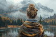 A young American woman stands with a blanket on her shoulders in front of a mountain lake wallpaper copy space