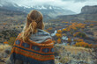Young American woman standing with a blanket, gazing at a valley and mountains view wallpaper copy space