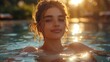 A blond woman is happily swimming in the fluid waters of a pool at sunset, leisurely enjoying her time bathing in the tranquil liquid