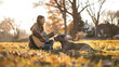 Young Woman playing an acoustic guitar and her dog enjoying a beautiful moment together on green lawn bathed in the golden sunlight