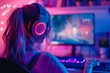 Blonde girl streamer games in a room with neon lighting. New equipment, headphones, powerful computer. 2nd person view