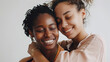 © BONI - Dos mujeres afroamericanas con los ojos cerrados dandose un abrazo con sus cabezas juntas y una sonrisa en la cara de felicidad.