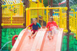© famveldman - Kids on water slide. Family in aqua theme park.