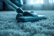 Close-up of a vacuum cleaner being used on a fluffy white carpet in a cozy home setting