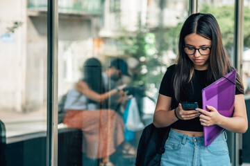 Wall Mural - girl student with phone outside school