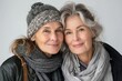 © Snapshot Lens - Portrait of old mother and mature daughter. Happy senior mom and adult daughter embracing with love on a white background, Generative AI