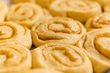 Fototapeta  - tray of cinnamon rolls ready to go into the oven, macro comfort food background