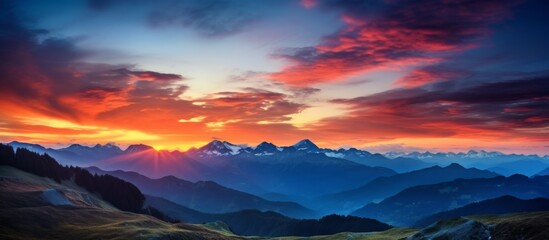 Poster - As the sun sets over the mountain range, the colorful sky reflects on the water, creating a stunning afterglow. Cumulus clouds drift in the atmosphere, enhancing the natural landscape