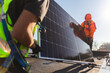 © Westend61 - Engineers carrying solar panel on rooftop at sunny day