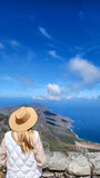 Fototapeta Miasta - A lady lookdown the sea from Table mountain in South africa
