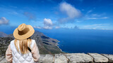 Fototapeta Miasta - A lady lookdown the sea from Table mountain in South africa