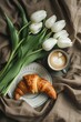 Cappuccino and croissant breakfast with white tulips on a table. Generated AI.