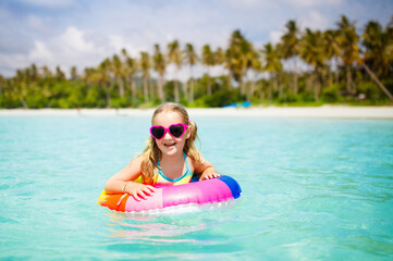 Wall Mural - Child on tropical beach. Sea vacation with kids.